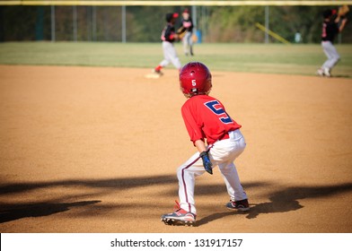 Baseball Player Looking To Steal Second Base.