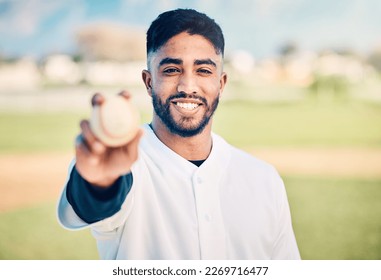 Baseball player, portrait and sportsman holding ball on match or game day on a sports field or pitch feeling happy. Sport, athlete and pitcher at training with a smile due to health and wellness - Powered by Shutterstock