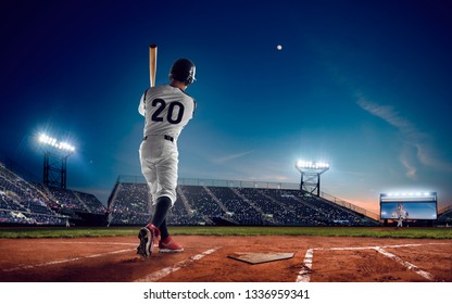 Baseball Player At Professional Baseball Stadium In Evening During A Game.