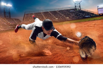 Baseball Player At Professional Baseball Stadium In Evening During A Game.