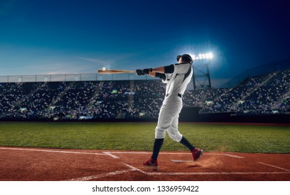 Baseball Player At Professional Baseball Stadium In Evening During A Game.