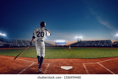 Baseball Player At Professional Baseball Stadium In Evening During A Game.