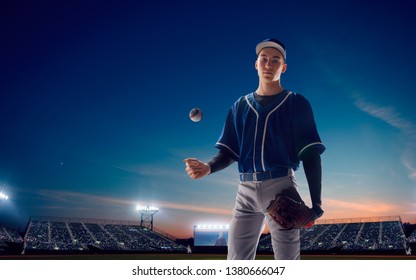 Baseball player at professional baseball stadium in evening during a game. - Powered by Shutterstock