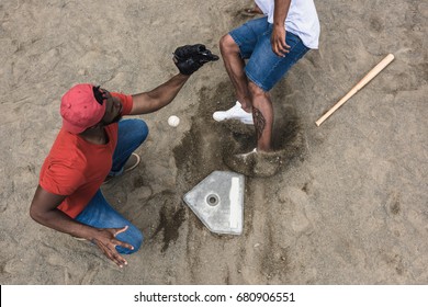 baseball player reaching base during game on court