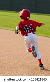 Baseball player running bases.