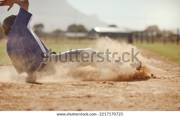 Baseball, baseball player running and diving for\
home plate in dirt during sport ball game competition on sand of\
baseball pitch. Sports man, ground slide and summer fitness\
training at Dallas\
Texas