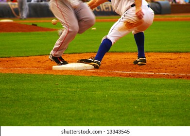 Baseball Player Running To First Base Ahead Of The Throw