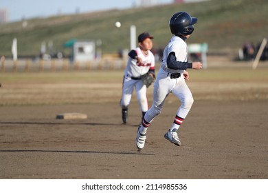 baseball player  is runninng toward third base. - Powered by Shutterstock