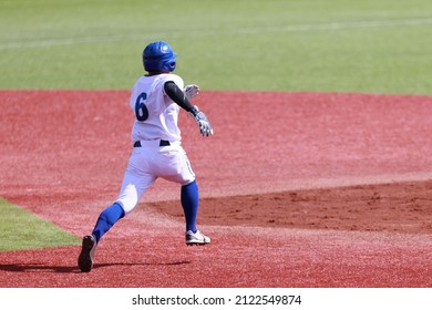 A Baseball Player Rushing To Second Base