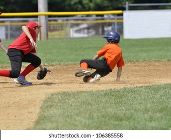 Baseball Player Sliding Into Second Base