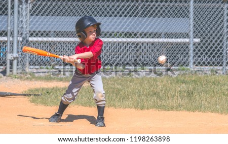 Baseball Player Swinging at Ball