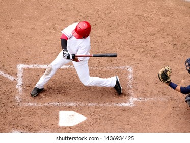 Baseball Player Swings At A Pitch