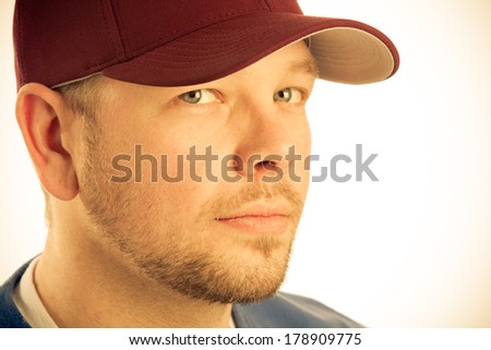 Baseball Player - This is a photo of a young man wearing a baseball cap. Shot in a warm retro color tone.