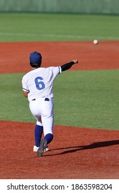 a baseball player throw a ball