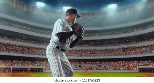 Baseball player throws the ball on professional baseball stadium