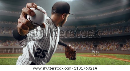Baseball player throws the ball on professional baseball stadium