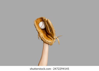 Baseball player's hand with glove caught ball, isolated on gray. Baseball, sports, championship - Powered by Shutterstock