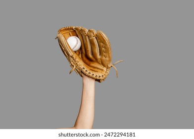 Baseball player's hand with glove caught ball, isolated on gray. Baseball, sports, championship - Powered by Shutterstock