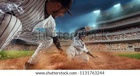 Baseball players on professional dramatic stadium. Baseball tagged out