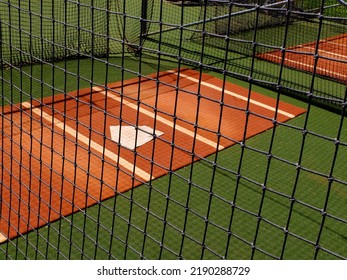 Baseball practice area fence with home plate for warm up pitching - Powered by Shutterstock