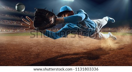 Baseball shortstop catches the ball on professional baseball stadium