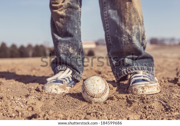 baseball and sneakers in\
a baseball field