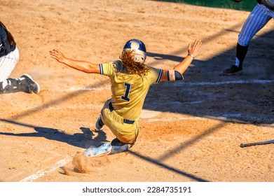 A Baseball Softball Player Is Sliding Into Home Plate - Powered by Shutterstock