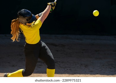 A Baseball Softball Player Is Swinging And Hitting The Ball - Powered by Shutterstock