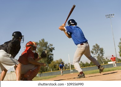 Baseball Striker Ready For A Shot With Keeper And Umpire In Position