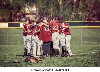 Baseball team in a huddle before a game.  Instagram toned image.