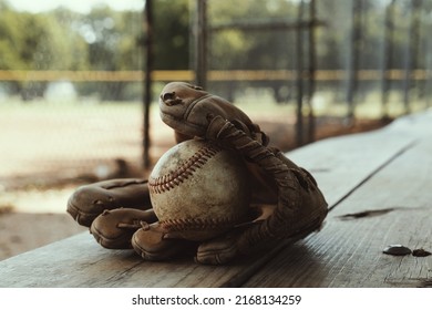 Baseball Team Sport With Ball And Glove On Dugout Bench Closeup, Field Blurred Background For Game.