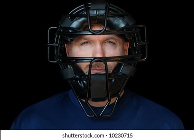 Baseball Umpire.  Head shot of handsome middle-aged man wearing an umpire's mask.  Isolated against black background. - Powered by Shutterstock