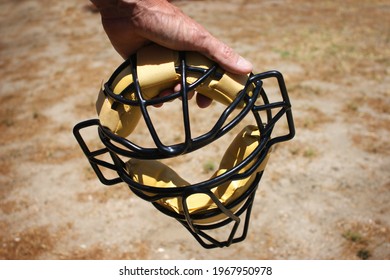 Baseball Umpire Holding Mask During Game