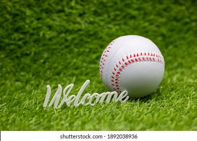 Baseball with welcome sign on green grass background for Party