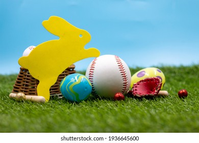 Baseball with Yellow bunny rabbit Easter egg on green grass and blue sky background for Easter Holiday