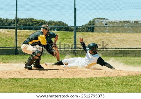 In baseball you need to be up for the challenge. Full length shot of a young baseball player reaching base during a match on the field.