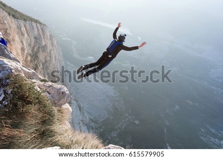 Basejumper jumping from the cliff in Italy