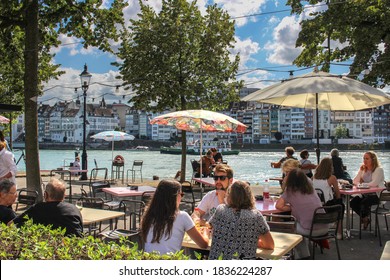 Basel / Switzerland - 19 August 2017: People relaxing at a bar next to the River Rhine in Basel in summer