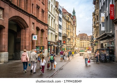 Basel Switzerland , 29 June 2020 : People on Freie Strasse main pedestrian shopping street and old buildings in Basel old town Switzerland