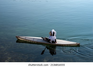 Basel - Switzerland - 9 March 2022 -  Portrait Of Masked Man Floating In A Canoe On The Rhine River