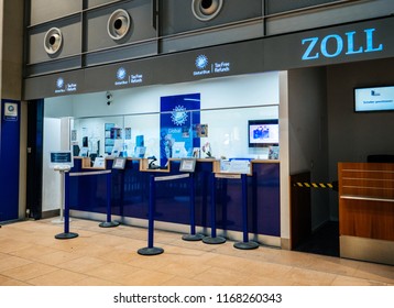 BASEL, SWITZERLAND - AUG 29, 2018: Interior Shot Of Customs Stand Inside Of Modern Airport With Design In Blue Colors With Big ZOLL Letter And GlobalBlue Tax Refund