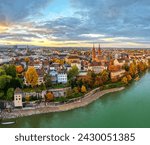 Basel, Switzerland on the Rhine River at dusk in autumn.