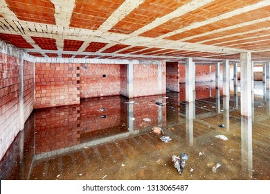 The Basement Of A Building Under Construction Is Filled With Dirty Flood Water 