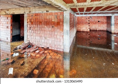 The Basement Of A Building Under Construction Is Filled With Dirty Flood Water 