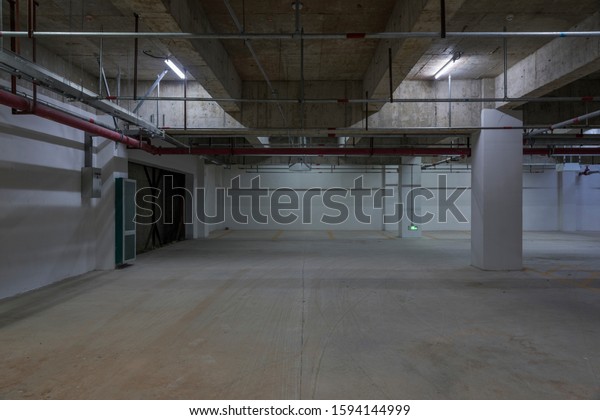 Basement\
concrete building interior space with fire\
pipes