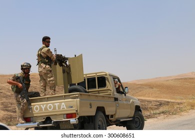 BASHIK FRONTLINE, KURDISTAN, IRAQ - 2015 JULY 25  - Two Unidentified Kurdish (peshmerga) Fighters In Back Of Truck At BASHIK (bashik) Base 25km From ISIS Controlled Mosul.  