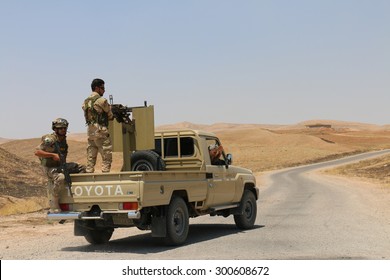 BASHIK FRONTLINE, KURDISTAN, IRAQ - 2015 JULY 25  - Two Unidentified Kurdish (peshmerga) Fighters In Back Of Truck At BASHIK (bashik) Base 25km From ISIS Controlled Mosul. 