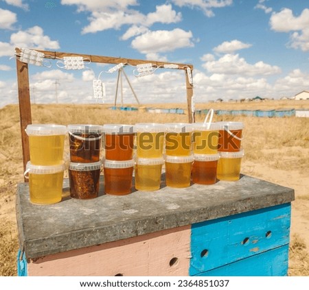 Bashkir bee honey is poured into jars. Sale of Bashkir honey.