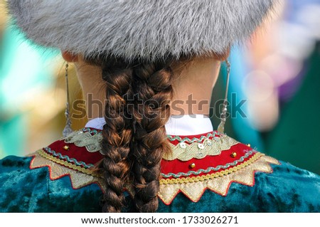 Bashkir girl with braids in a traditional dress