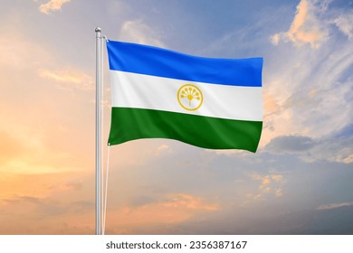 Bashkortostan flag waving on sundown sky